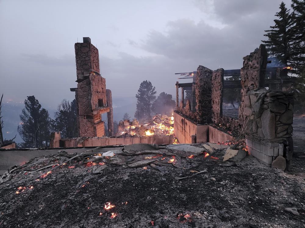 The remains of a home left after a wildfire spread through the Ruidoso, N.M., on Wednesday.