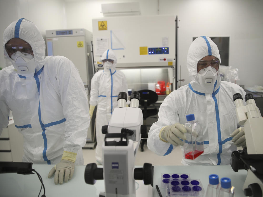 Laboratory technicians work at the Valneva headquarters in Saint-Herblain, western France, Wednesday, Feb.3, 2021.