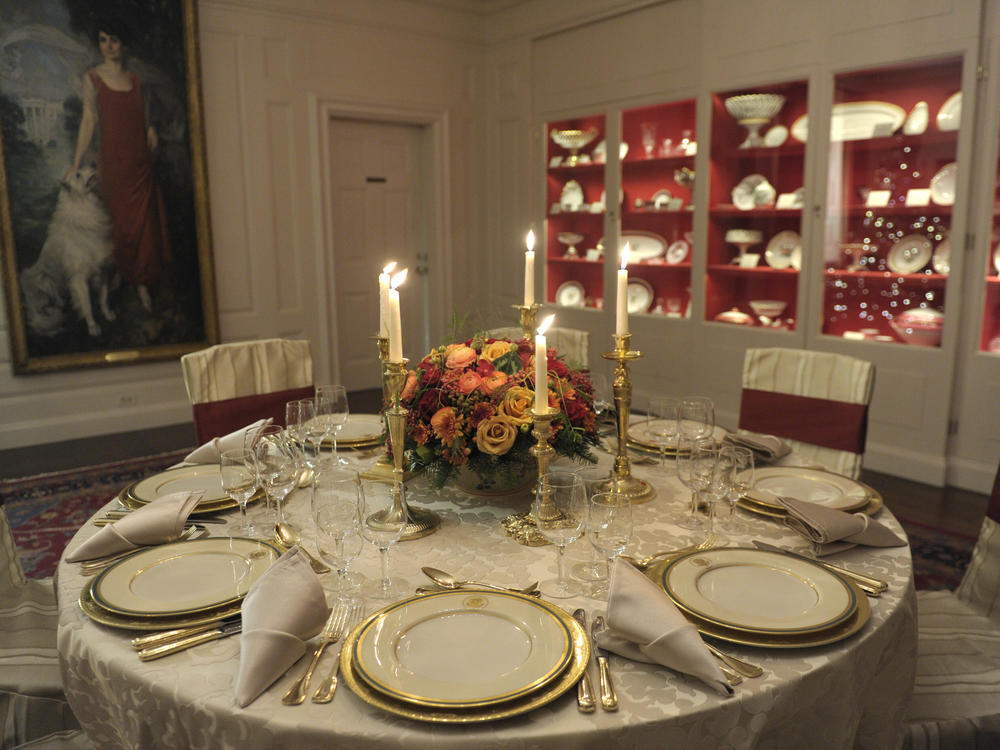 The Truman china set is displayed on a table in the White House's China Room. This set, selected by first lady Bess Truman in 1951, is the first state china service to feature the presidential coat of arms as redesigned by President Harry Truman in 1945.