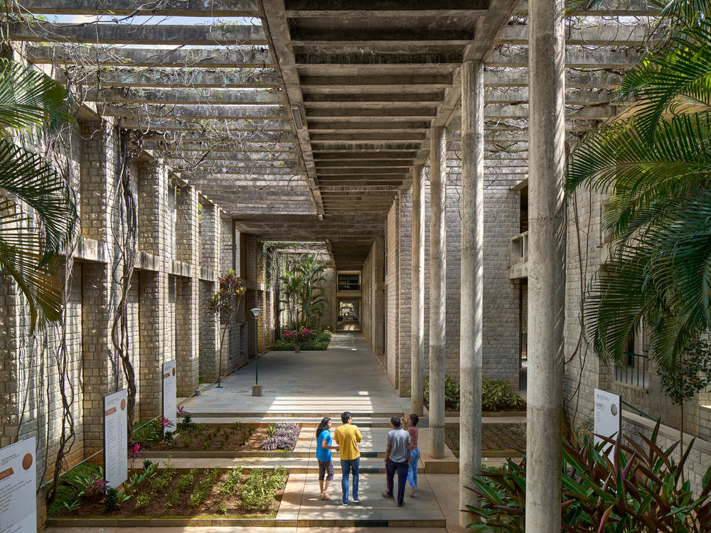 The Indian Institute of Management in Bangalore, India has an open-air design suitable for the hot and humid climate. The architect, Balkrishna V. Doshi, was involved in the design of new schools and in 2018 became the first South Asian to win the Pritzker Prize in Architecture.