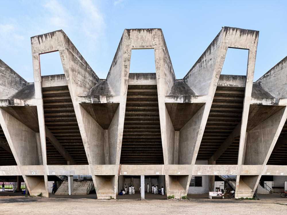 The Sardar Vallabhbhai Patel Municipal Stadium in Ahmedabad, India, built from 1959 to 1966. The use of concrete, cast on site, was a hallmark of post-colonial design, reflecting the affordability and ease of mixing and pouring this inexpensive material. The building is notable for the cantilevered roof that appears to float above the stadium.