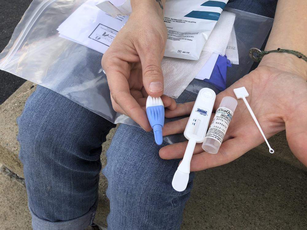 Brooke Parker displays an HIV testing kit in Charleston, W.Va. amid one of the nation's highest spikes of HIV cases.