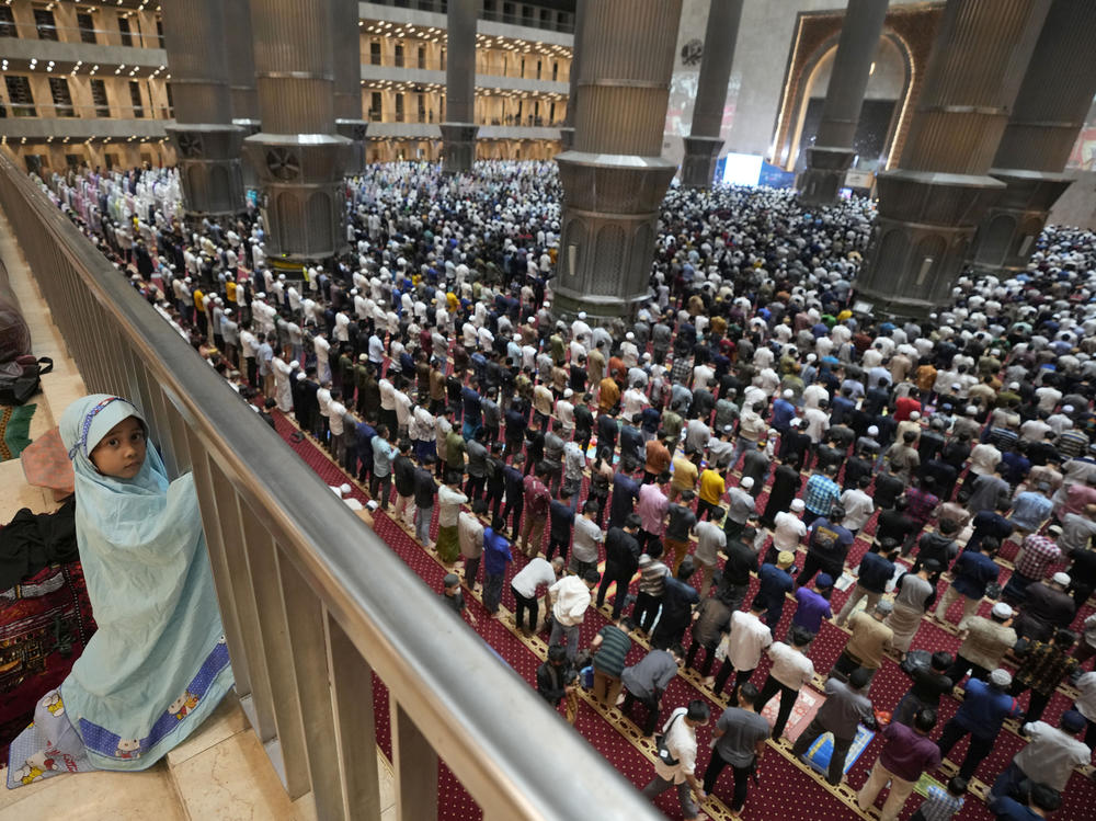 A little girl looks on during an evening prayer on the eve of the holy fasting month of Ramadan at Istiqlal Mosque in Jakarta, Indonesia.
