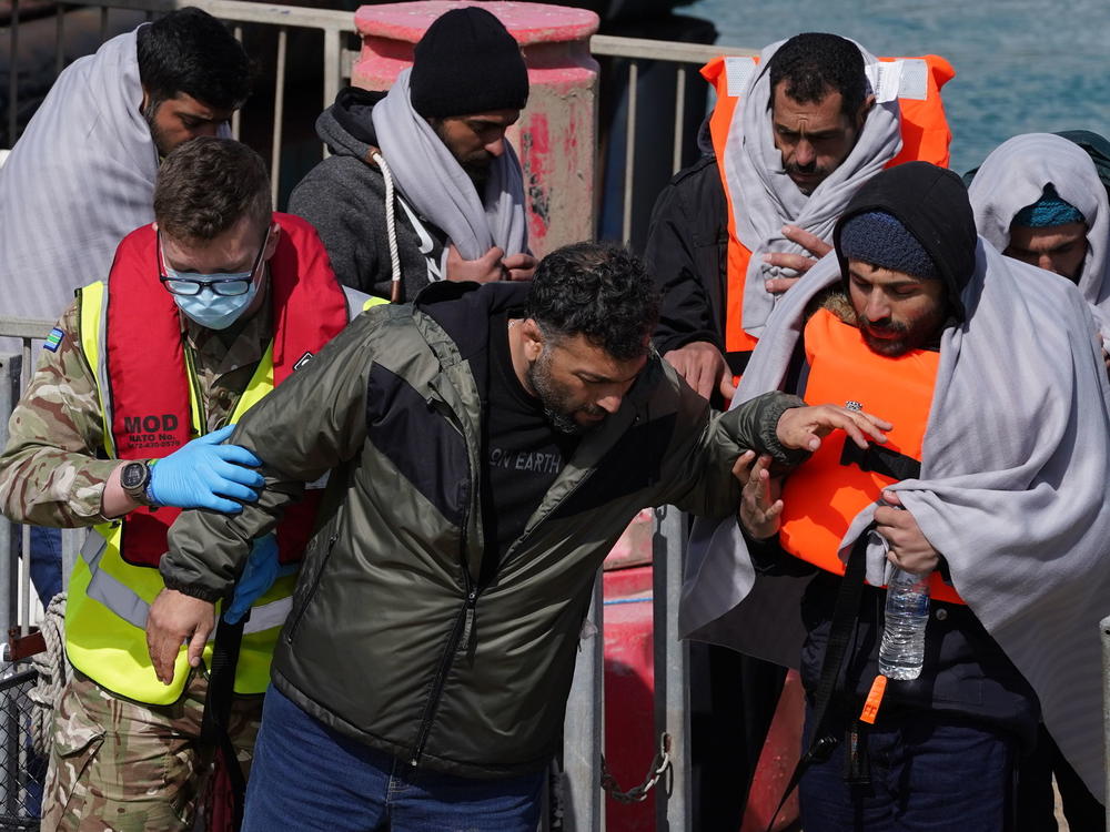 A group of people thought to be migrants are brought in to Dover, Kent, by the RNLI, following a small boat incident in the Channel, Thursday April 14, 2022.