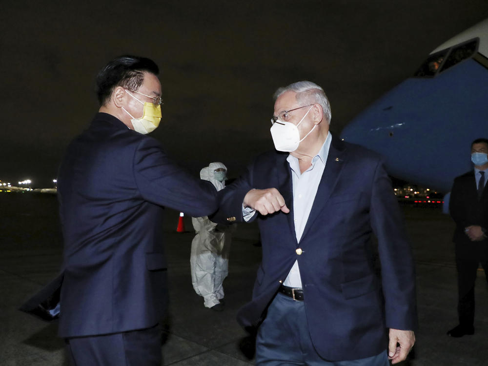 In this photo released by Taiwan's Ministry of Foreign Affairs, Taiwan's Foreign Minister Joseph Wu, left, greets Sen. Bob Menendez, D-N.J., as he arrives in Taipei, Taiwan, Thursday, April 14, 2022.