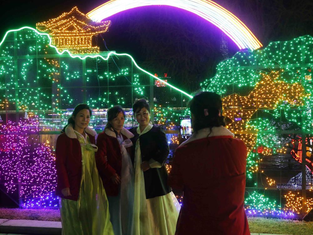 Citizens take a photo at a light festival in celebration of 110th birth anniversary of their late leader Kim Il Sung at Kim Il Sung Square in Pyongyang, North Korea Thursday, April 14, 2022.