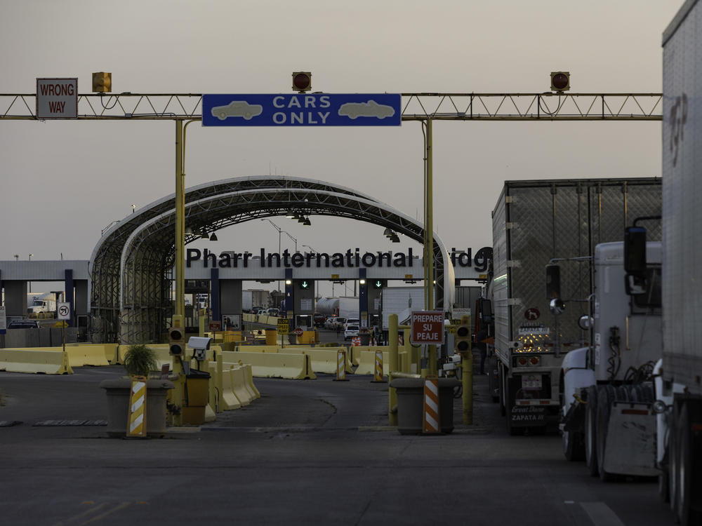 Several dozen commercial trucks wait to cross the Pharr-Reynosa International bridge on April 13 in Pharr, Texas.