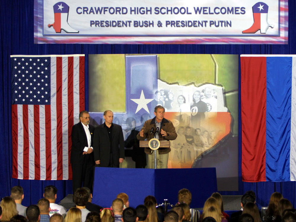 President George W. Bush and Russian President Vladimir Putin speak during a visit to Crawford High School in Crawford, Texas, on Nov. 15, 2001. The appearance wrapped up a summit of the newly elected presidents in Texas.