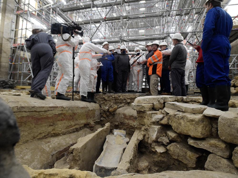 France's Culture Minister Roselyne Bachelot (center left) visits the Notre Dame Cathedral archaeological research site in Paris on March 15 after the discovery of a 14th century lead sarcophagus.