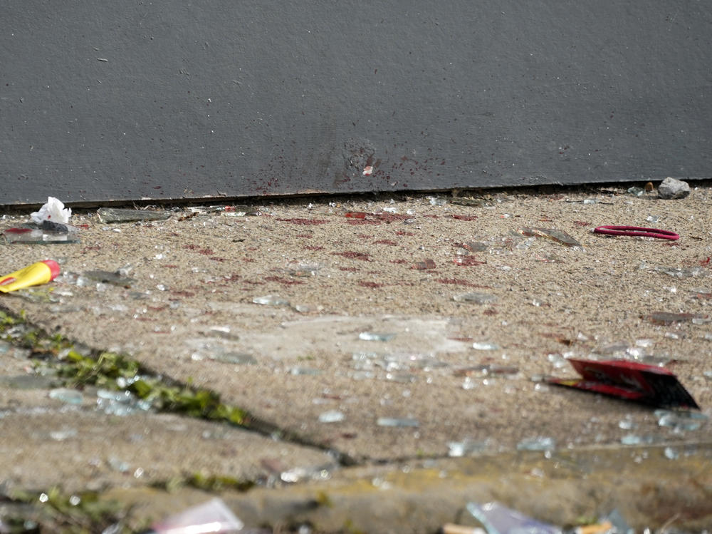 What appears to be blood and broken glass on the sidewalk outside the AirBnB rental property a shooting took place at a house party in Pittsburgh early Sunday morning.