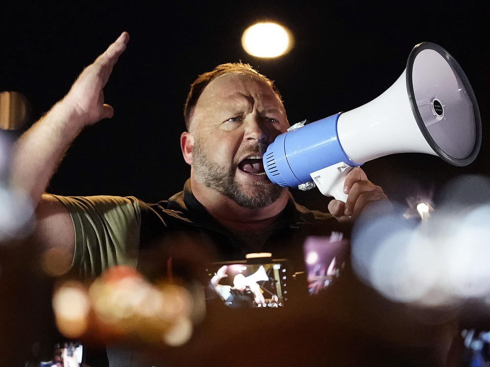 Infowars host and conspiracy theorist Alex Jones rallies pro-Trump supporters outside the Maricopa County Recorder's Office, on Nov. 5, 2020, in Phoenix.