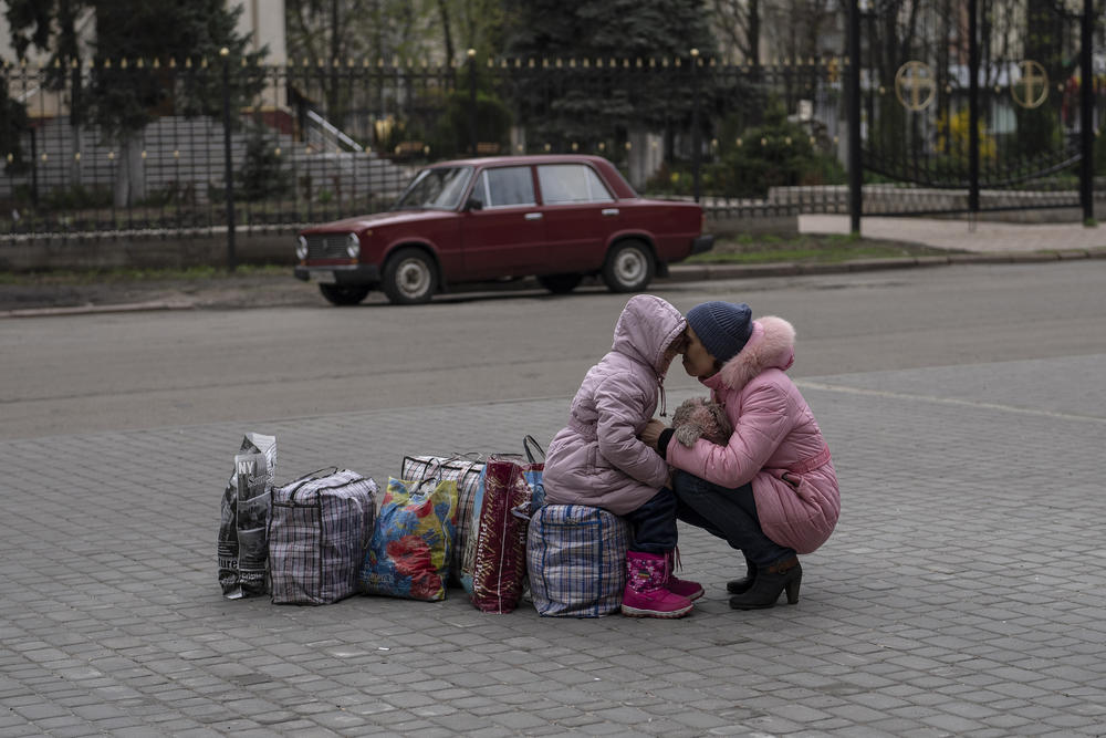 <strong>April 16:</strong> A mother hugs her daughter as they wait for a bus to flee the city of Sloviansk, in the Donetsk Oblast, to travel to Rivne, in western Ukraine.