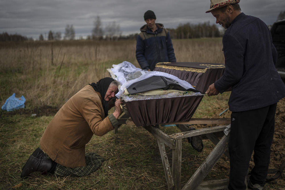 <strong>April 16:</strong> Nadiya Trubchaninova, 70, cries while holding the coffin of her son Vadym, 48, during his funeral in a cemetery on the outskirts of Kyiv after he was killed by Russian soldiers on March 30 in Bucha.