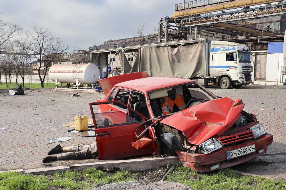 <strong>April 16:</strong> A body of a civilian lies next to a damaged car near the Illich Iron & Steel Works Metallurgical Plant, the second largest metallurgical enterprise in Ukraine, in an area controlled by Russian-backed separatist forces in Mariupol, Ukraine.