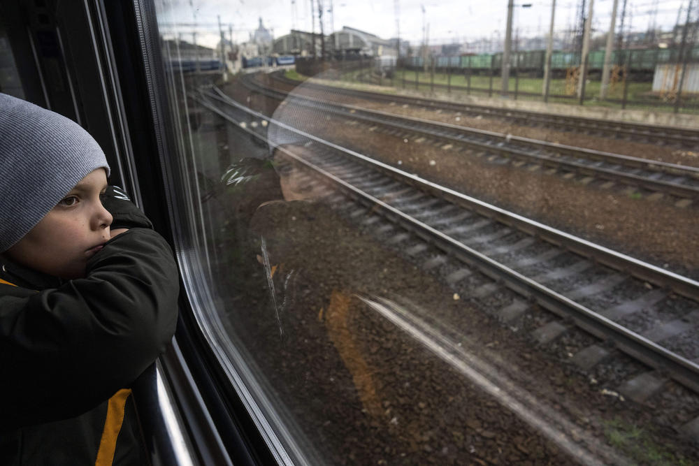 <strong>April 17:</strong> Sergei looks out of the window of a train minutes before arriving with his family in Lviv, from Kyiv, Ukraine.