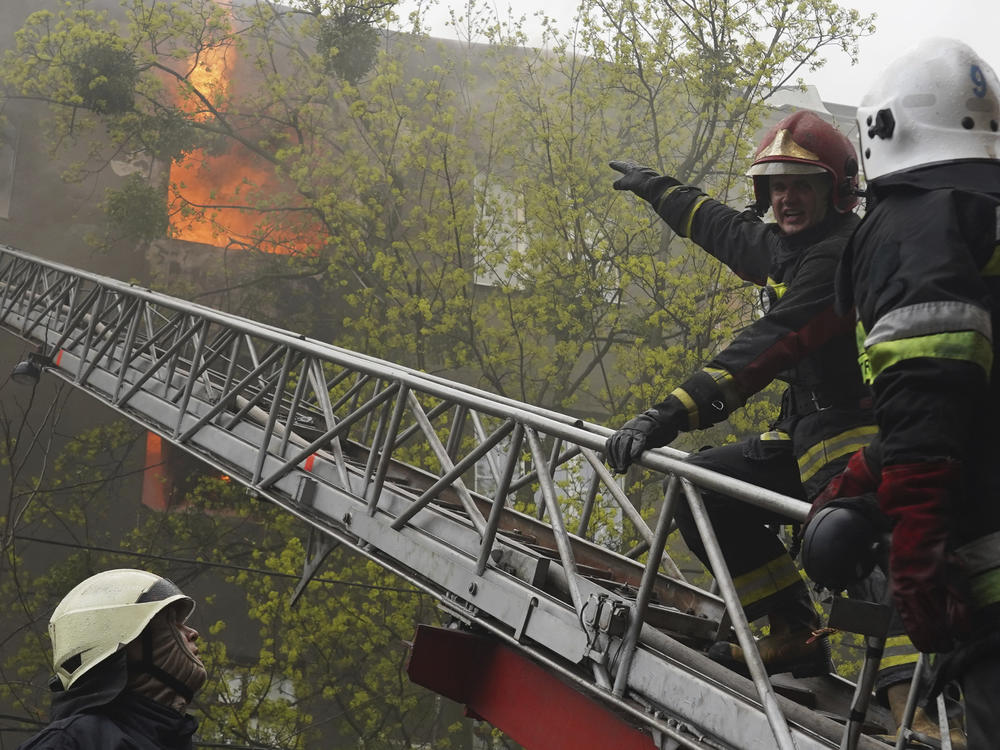 Firefighters work to extinguish fire at an apartment building after a Russian attack in Kharkiv, Ukraine, Sunday, April 17, 2022.