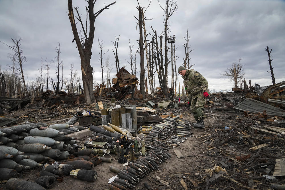 <strong>April 18:</strong> An interior ministry sapper collects unexploded shells, grenades and other devices in Hostomel, a suburb of Kyiv.