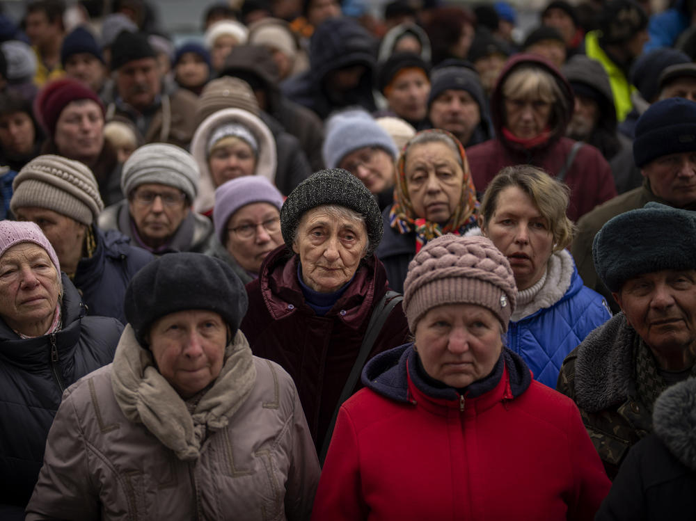<strong>April 18:</strong> Ukrainians wait as Red Cross relief workers distribute food in Bucha, on the outskirts of Kyiv, Ukraine.