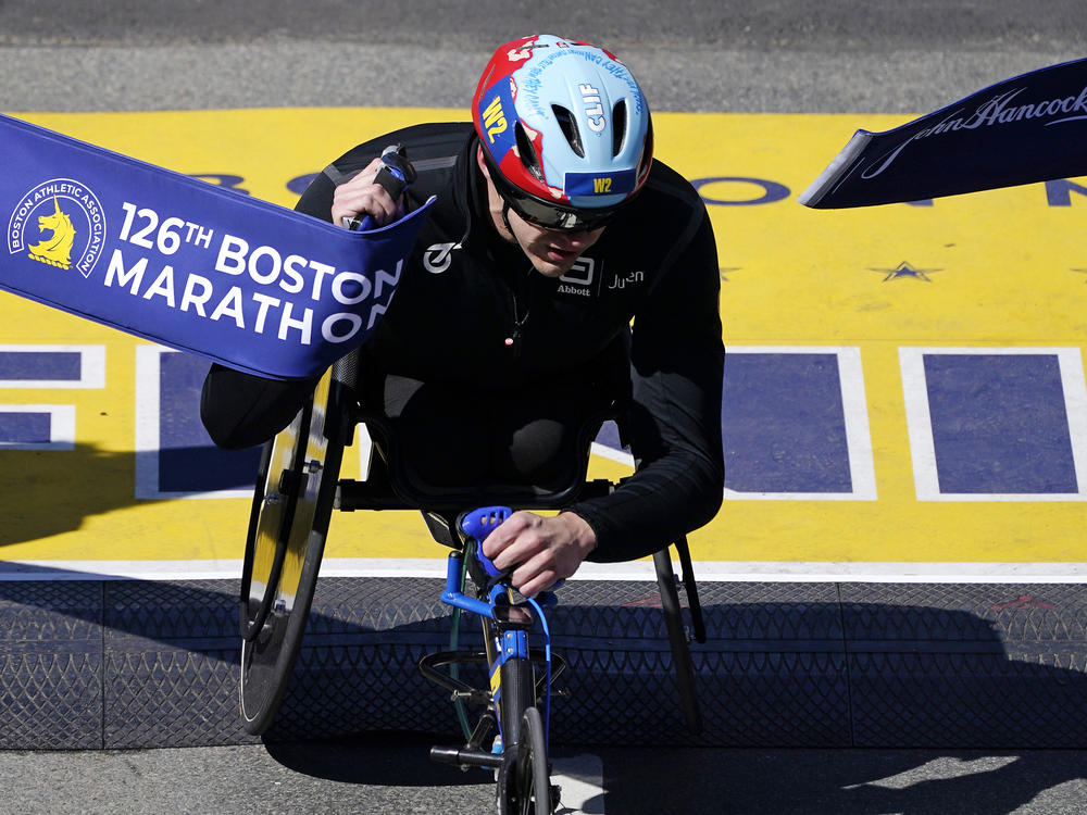 Daniel Romanchuk, of the United States, breaks the tape to win the men's wheelchair division of the Boston Marathon on Monday.