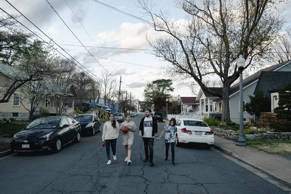 The Koliubaiev family walks to Penrose Park in Arlington to play basketball on April 12.