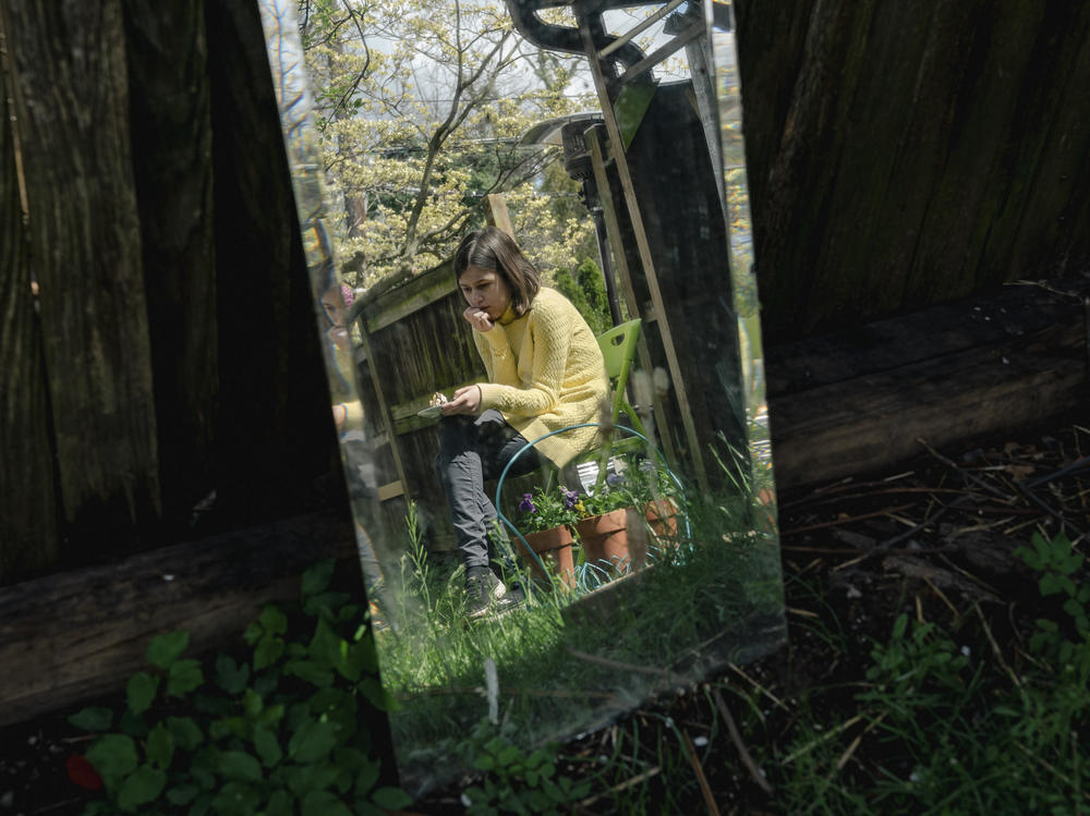 Amira, the younger daughter in the Koliubaiev family, sits quietly by herself in Arlington, Va., on April 9. She and her mother and sister are staying with a host family after fleeing the war in Ukraine.