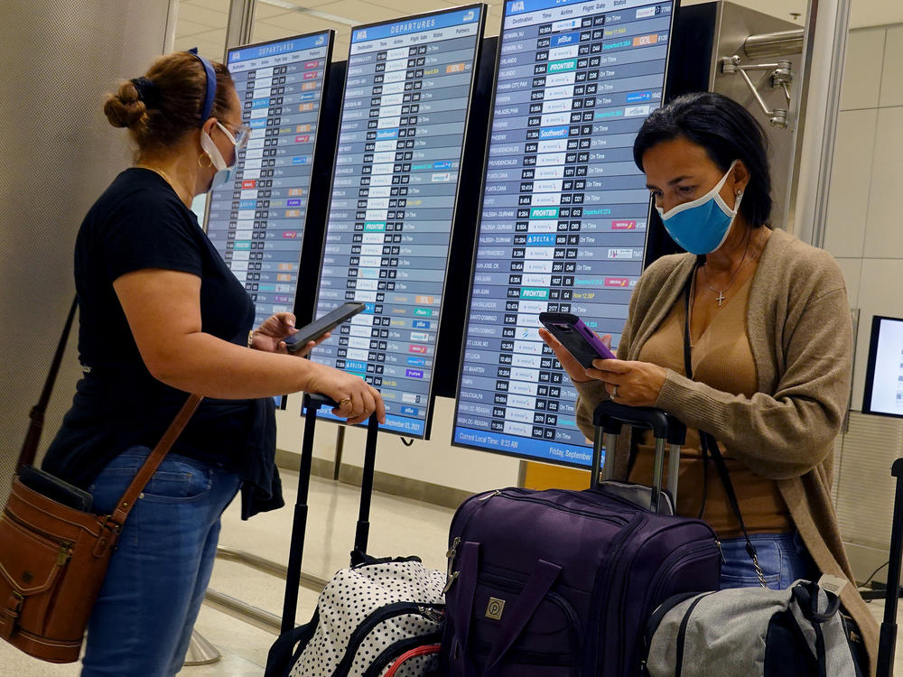 Travelers make their way through the Miami International Airport in September 2021 in Miami, Florida.