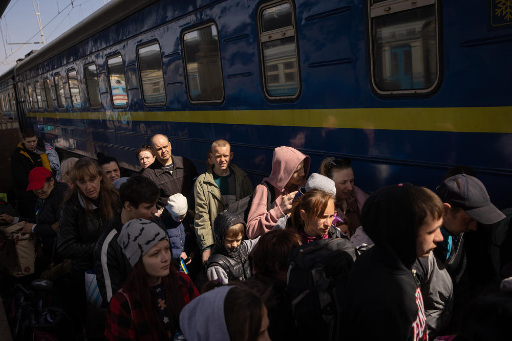 <strong>April 16:</strong> People evacuating eastern Ukraine board a train in Kharkiv that's bound for Lviv.