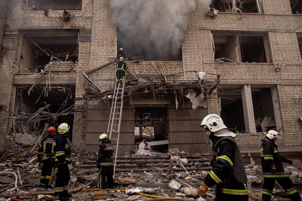 <strong>April 16:</strong> Firefighters work to extinguish a fire at a shopping center and surrounding buildings after a Russian missile strike in Kharkiv, Ukraine.