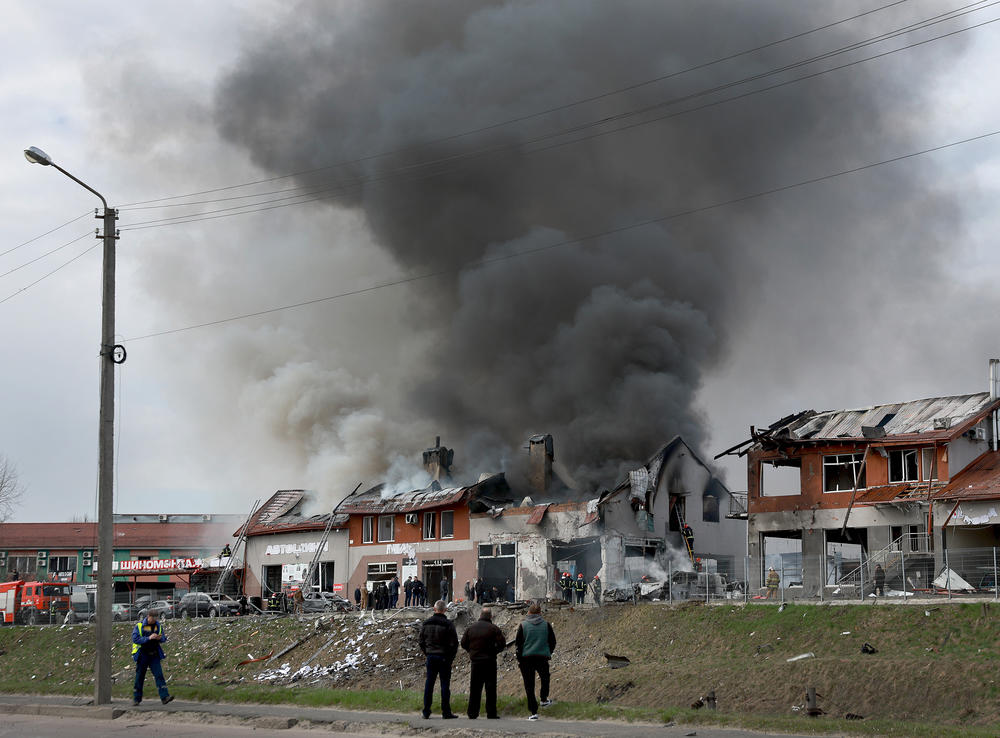 <strong>April 18:</strong> Firefighters battle a blaze after a civilian building was hit by a Russian missile in Lviv. Officials say at least seven people were killed and another 11 wounded in missile strikes in different areas of the city overnight.