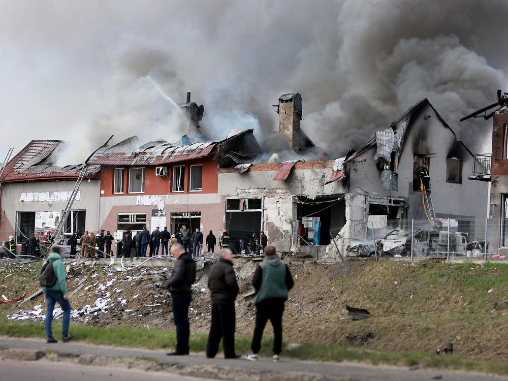 Firefighters battle a blaze after a civilian building was hit by a Russian missile on Monday in Lviv, Ukraine. Ukrainian officials said at least seven people were killed and more were wounded in missile strikes in different areas of the city.