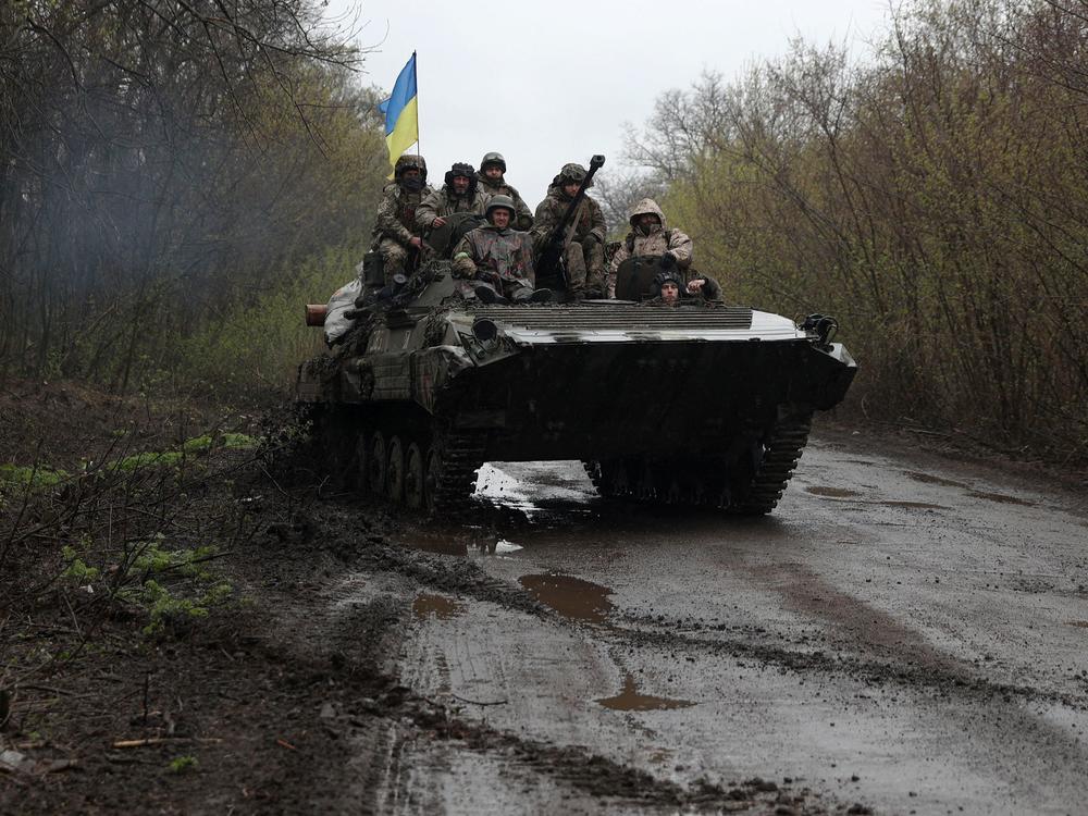Ukrainian soldiers stand on an armored personnel carrier not far from the front line with Russian troops in Izyum district, Kharkiv region, on Monday.