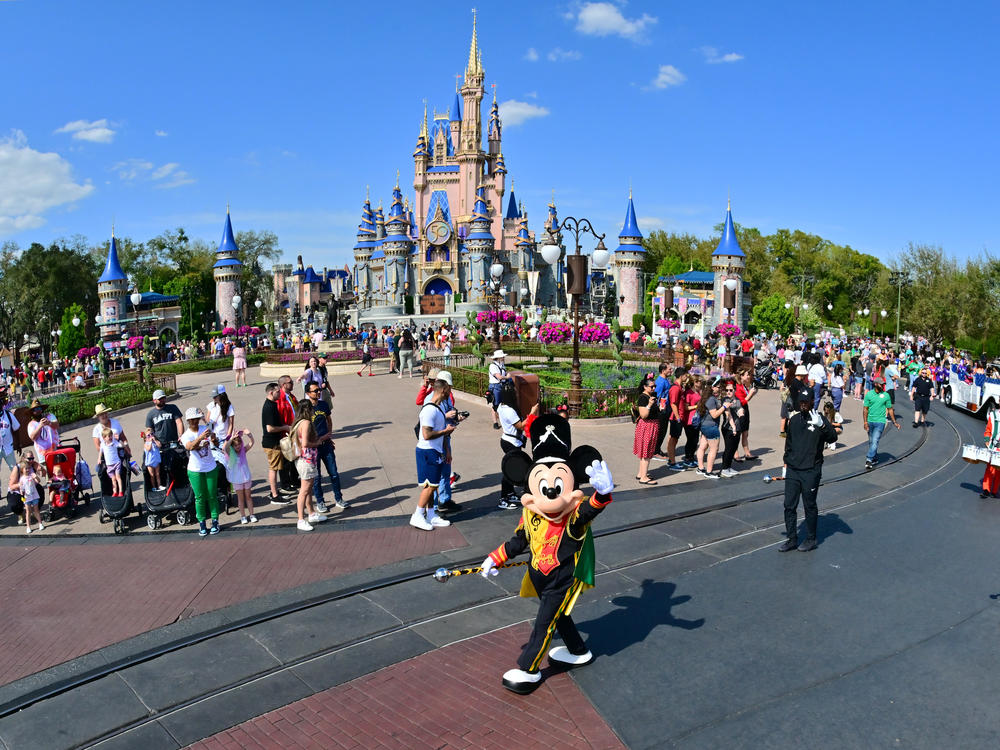Mickey Mouse waves to fans during a parade at Walt Disney World Resort on March 03, 2022 in Lake Buena Vista, Florida.