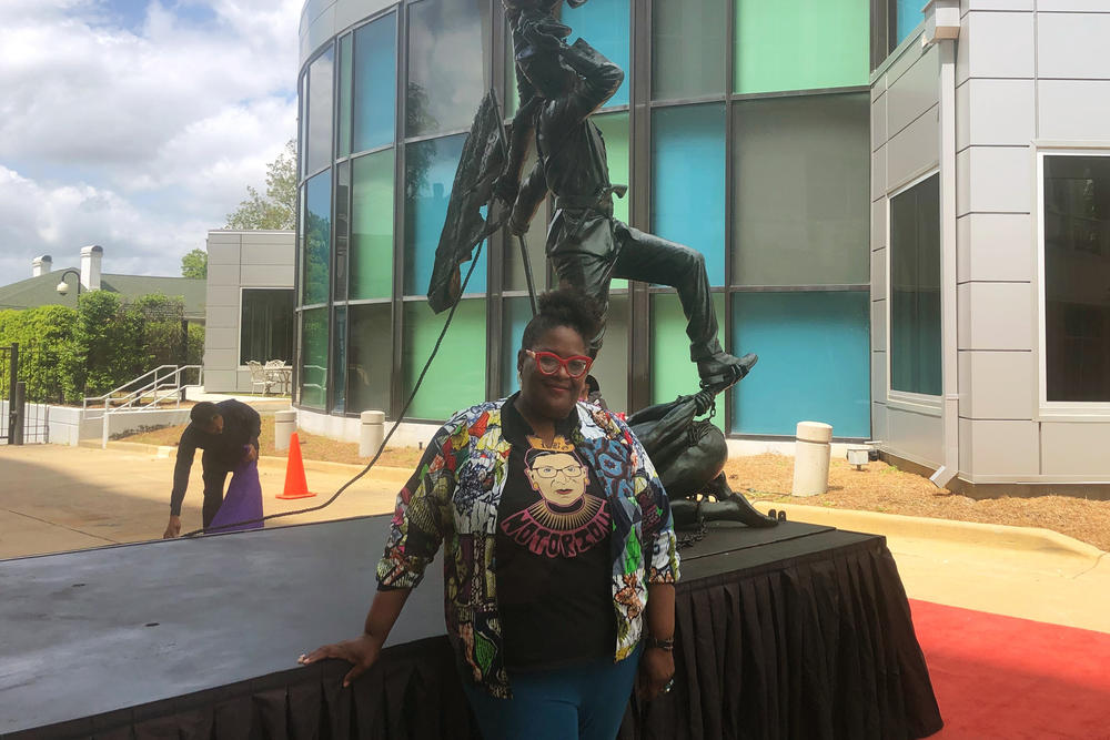 Artist Michelle Browder in front of a sculpture called <em>Blank Slate</em> by the Ghanaian artist Kwame Akoto-Bamfo.