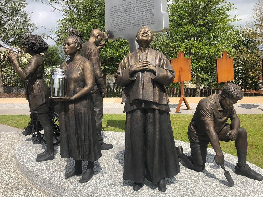 Artist Branly Cadet's <em>Arise</em> sculpture at the National Memorial for Peace and Justice in Montgomery, Ala.,<em> </em>portrays community activists.