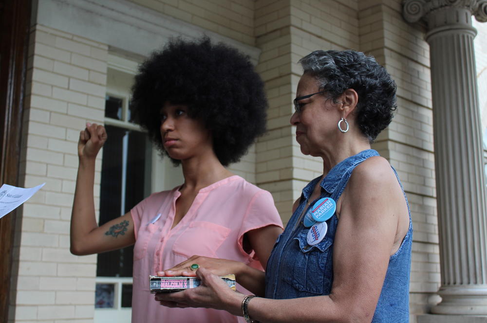 Parker was sworn in as District 2 county commissioner on a copy of the <em>A</em><em>utobiography of Malcolm X</em>, next to their mother.