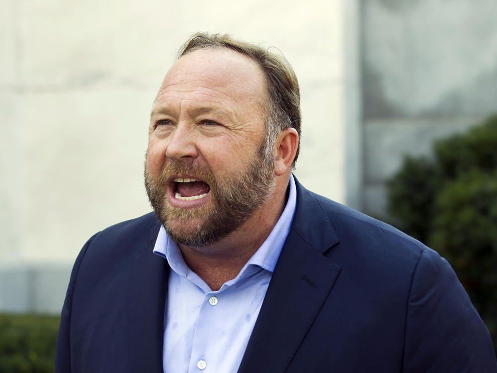 Infowars host and conspiracy theorist Alex Jones speaks in Washington, D.C., on Sept. 5, 2018. A Texas judge on Wednesday pushed back a trial over how much Jones should pay the families of Sandy Hook victims.
