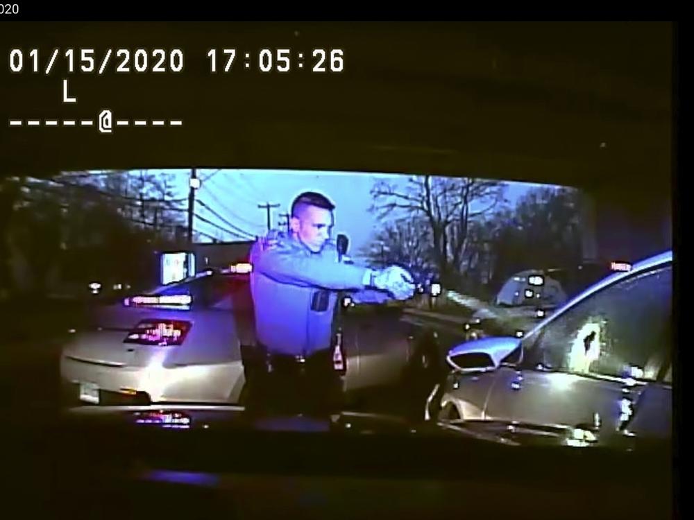This Jan. 15, 2020, still image from dashboard camera video released by the Connecticut State Police shows Trooper Brian North after discharging his weapon and fatally shooting Mubarak Soulemane following a high-speed chase.