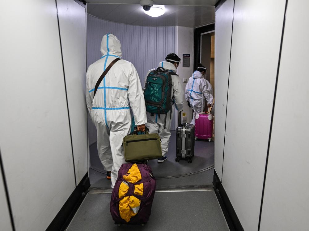 Masks are just one protective measure for these airline passengers arriving in Shanghai from Paris.