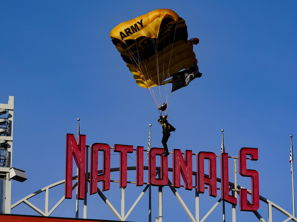 A member of the U.S. Army Parachute Team descends into National Park before a baseball game between the Washington Nationals and the Arizona Diamondbacks on Wednesday in Washington. The plane the team flew on entered restricted airspace on the way to the park, triggering an evacuation of the U.S. Capitol.