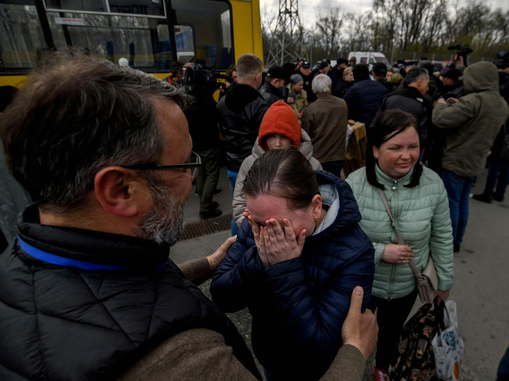 People fleeing the Ukrainian city of Mariupol arrive at a registration center for internally displaced people in Zaporizhzhia on Thursday. They traveled in a small convoy that crossed through territory held by Russian forces, after the opening of a humanitarian corridor.