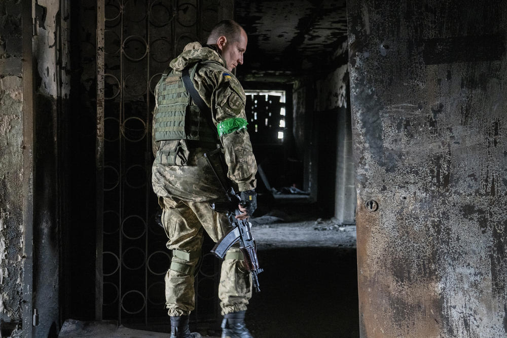 Capt. Daniil, public affairs officer with the Ukrainian military, explores the remains of a building in Mala Rohan that Russian soldiers used as a temporary base while occupying the area. Ukrainian forces drove them out.