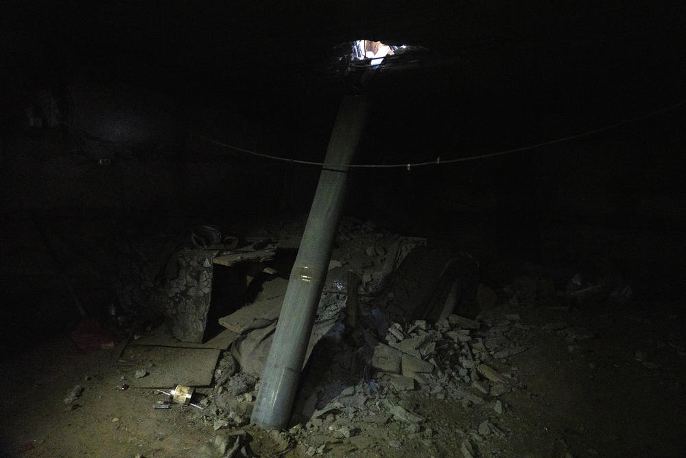 The casing of a Ukrainian Grad missile stands upright in the basement of a warehouse previously used as a temporary barracks and field hospital by occupying Russian soldiers in Mala Rohan.