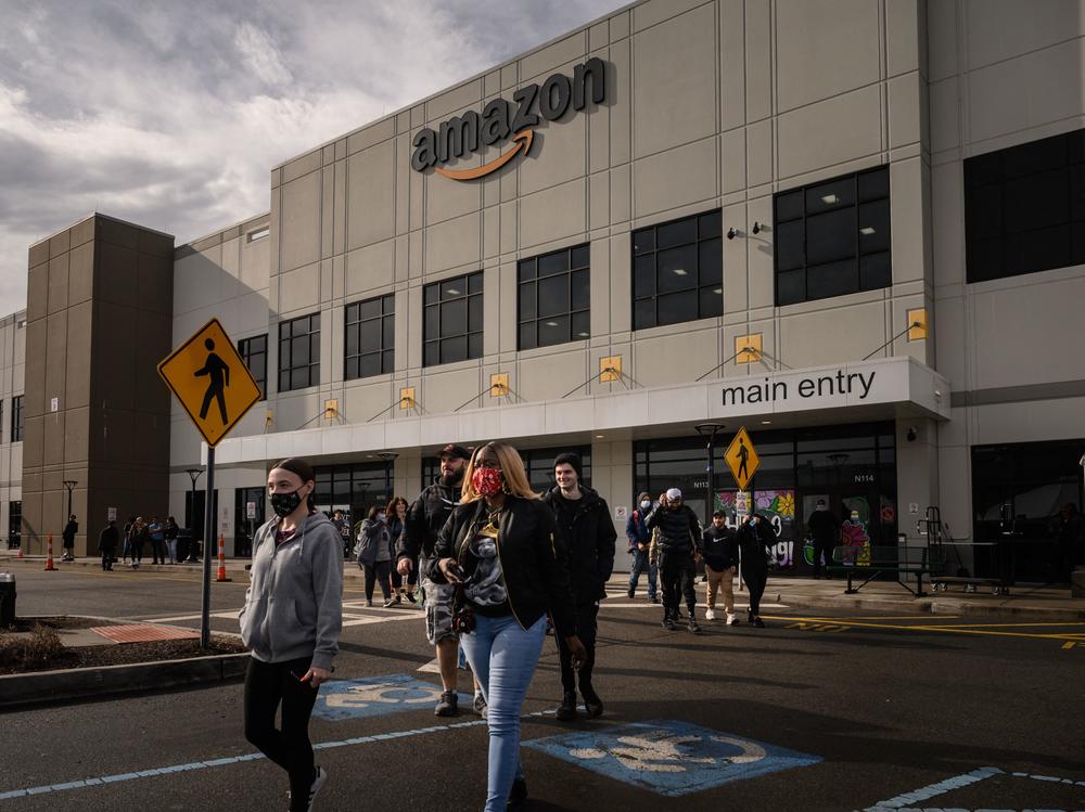 Workers walk to cast their votes over whether or not to unionize, at an Amazon warehouse on Staten Island on March 25, 2022. Another Amazon warehouse across the street began voting on a union on Monday.