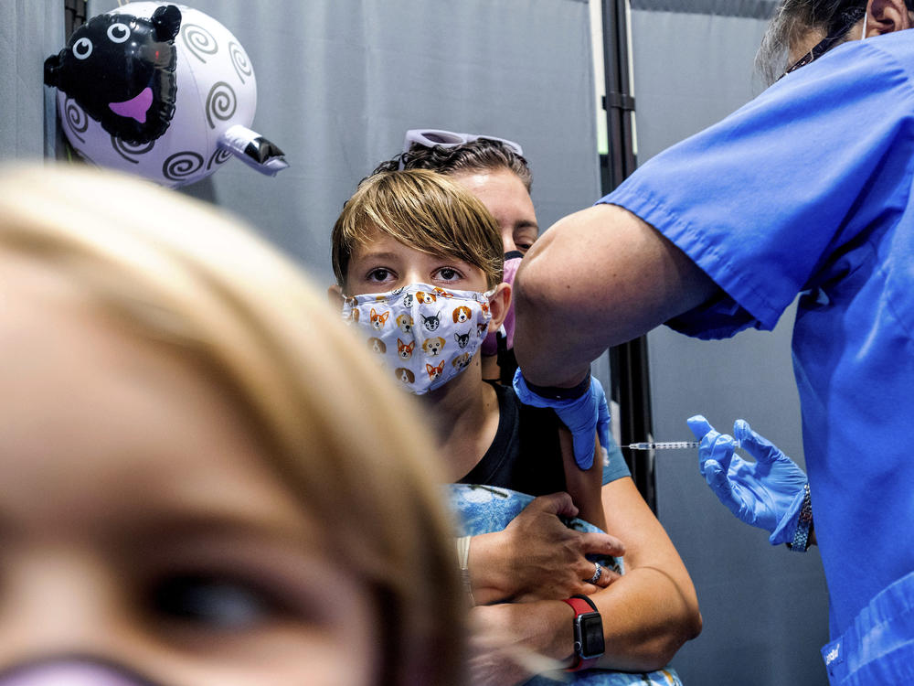 Finn Washburn, 9, receives an injection of the Pfizer-BioNTech COVID-19 vaccine in San Jose, Calif., in November. Now the pharmaceutical companies are seeking authorization to give kids a booster dose of the vaccine.