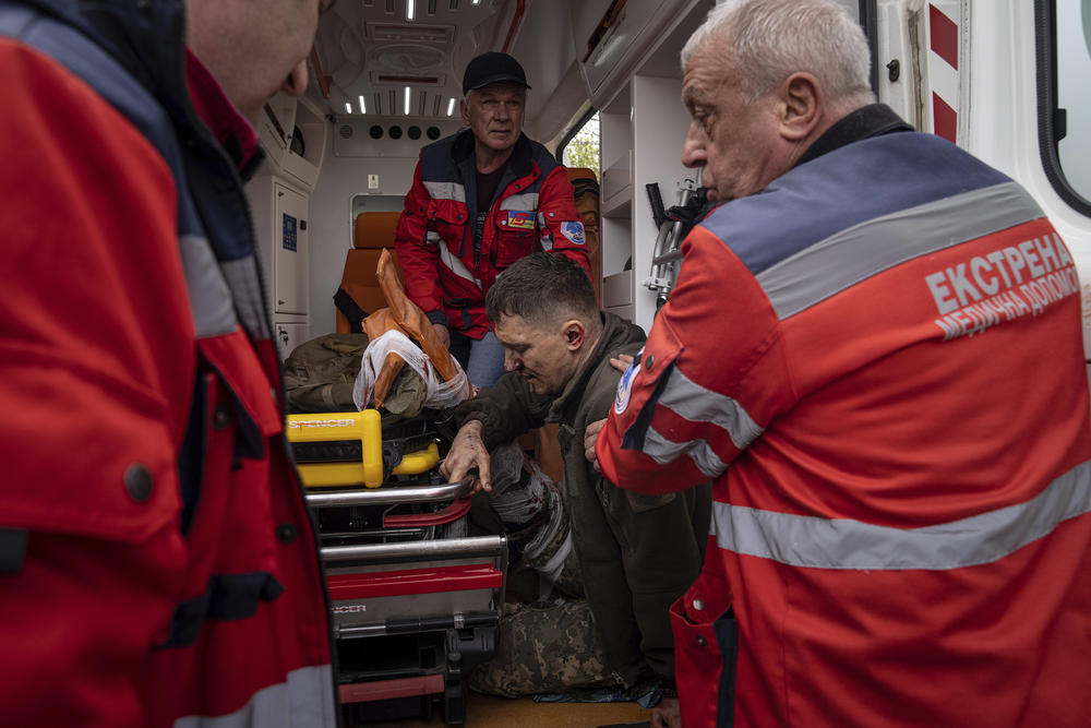 <strong>April 23:</strong> Ambulance workers help an injured Ukrainian serviceman to move to a hospital in Donetsk region, eastern Ukraine.