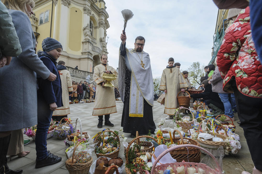 <strong>April 23:</strong> A Ukrainian priest blesses believers as they collect traditional cakes and painted eggs prepared for an Easter celebration in the in Lviv, Ukraine.