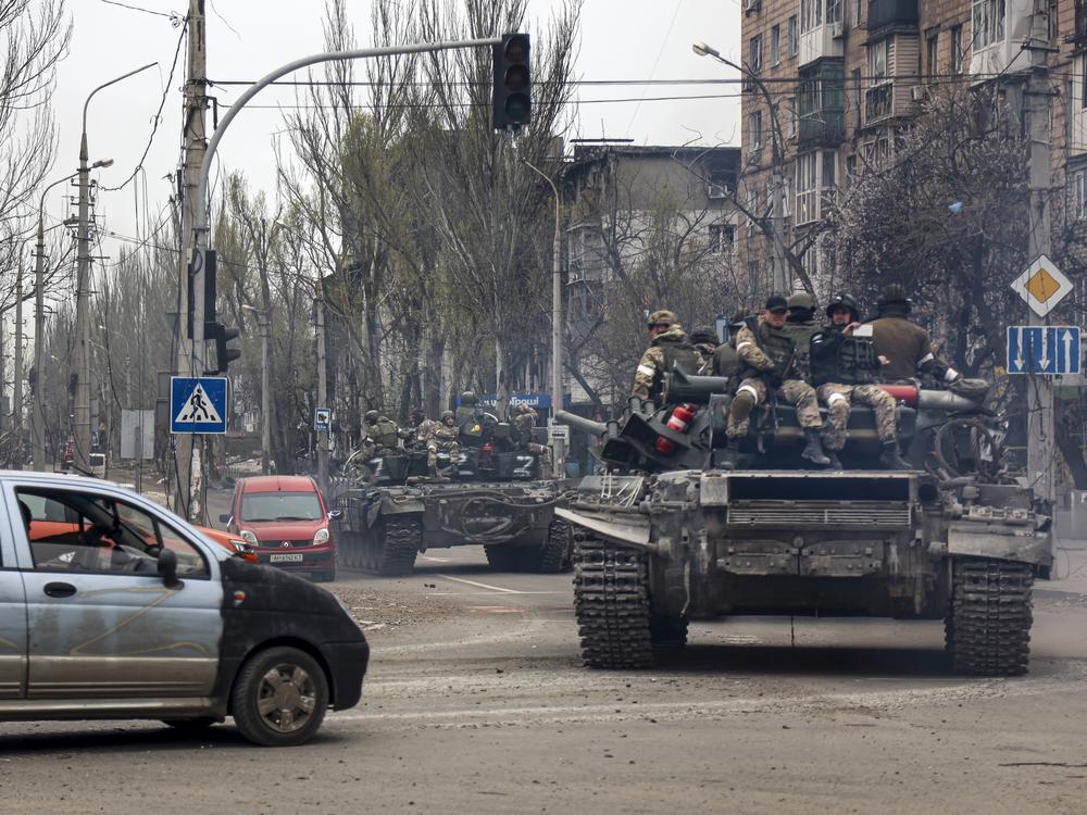 Russian tanks roll along a street in an area controlled by Russian-backed separatist forces in Mariupol, Ukraine, on April 23, 2022.