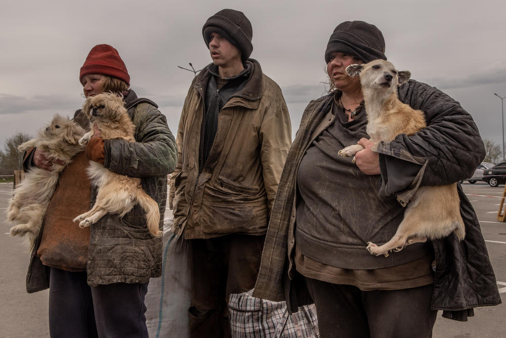 <strong>April 23:</strong> A family from Myrne, a town which is currently occupied by Russian forces wait to register with police at an evacuation point for people fleeing from Mariupol, Melitopol and surrounding towns under Russian control in Zaporizhzhia, Ukraine.