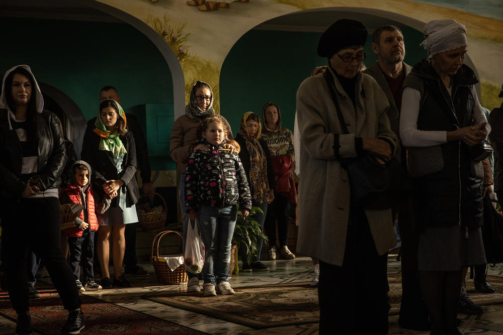 <strong>April 24:</strong> People take part in an Easter Sunday service at a church in Zaporizhzhia, Ukraine. Orthodox Easter celebrations come as Ukraine marks two months since the start of Russia's February 24 invasion, a war that has killed untold thousands of civilians and soldiers.