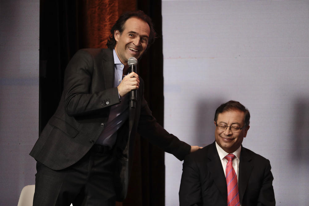 Federico Gutiérrez, a candidate with the Team for Colombia coalition, touches the shoulder of Gustavo Petro, candidate with the Historic Pact coalition, during a debate in Bogotá, Colombia, Jan. 25.